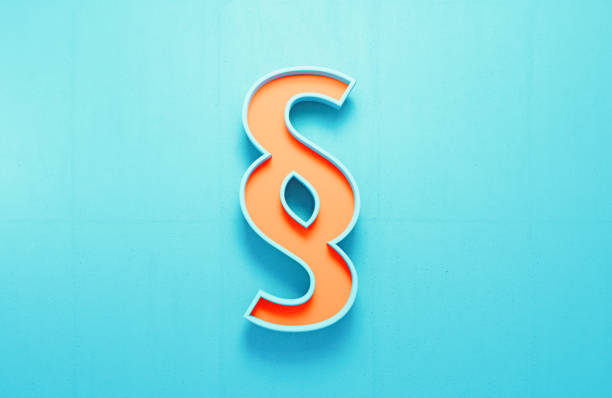 Orange pilcrow law symbol on blue concrete wall background. Horizontal composition.