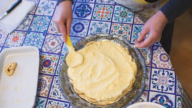 Slowly add a layer of custard to the cake