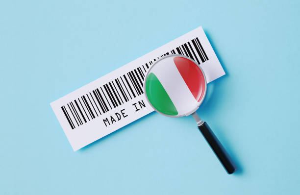Magnifier and Italian flag printed barcode label on blue background. Horizontal composition. Made In China concept.