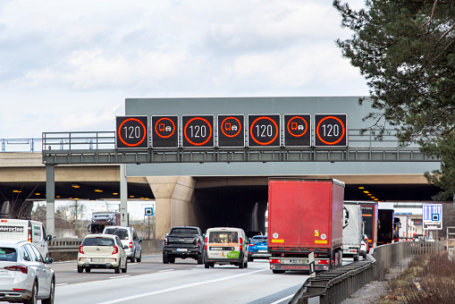 Frankfurt, Germany - February 13, 2024: Large trucks and dense traffic on autobahn A3 between Kelsterbach and Frankfurt Airport. The Bundesautobahn 3 (abbreviated as BAB 3 or A 3) is a highway in Germany that links the border to the Netherlands near Wesel in the northwest to the Austrian border near Passau in the southeast.