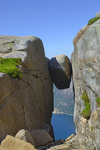 Kjeragbolten, Travel in Norway Kjerag mountains, extreme vacations, adventure where the famous boulder stuck at an altitude of 984 meters above Lysefjorden on Mount Kjerag, Norway