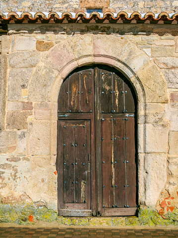 Antique aged wooden door of a European rural village.