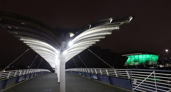 Footbridge to Scottish Exhibition and Conference Centre, Glasgow, at night with Ovo arena lit in green