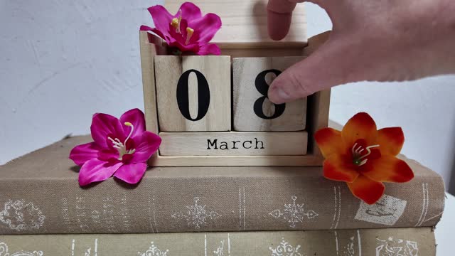 March 8 holiday concept. Put a cube with the number 8 on a wooden calendar