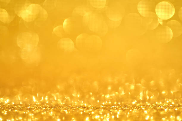 Abstract Christmas background with bokeh and defocused lights. Golden background.
