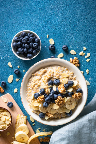 istock Oatmeal porrige in craft bowl at white background. 2010545080