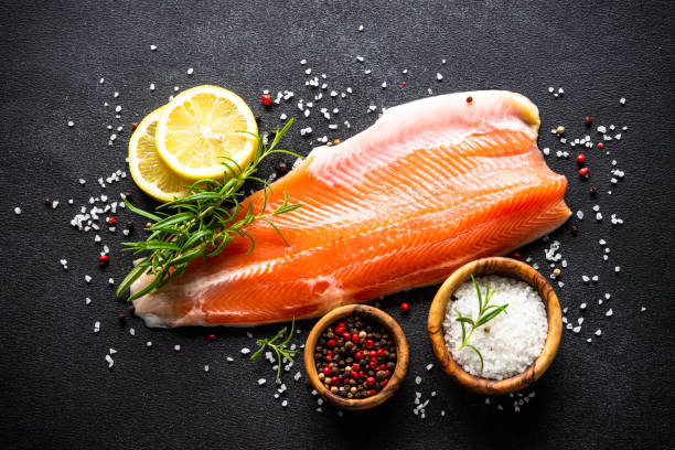 istock Fresh salmon fish at black top view. 2010552835