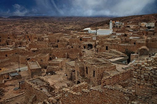 View of Toujane, a Berber mountain village in southern Tunisia. A village with stone houses that blends into the landscape if there were not these few  whitewashed buildings. Nearly 200 of those houses are uninhabited.