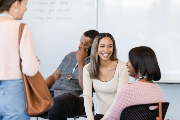 istock Female interns smile and enjoy conversation while they wait for the meeting to begin 2010565460