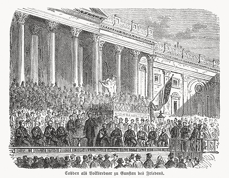 Historical illustration of Richard Cobden (English Radical and Liberal politician, 1804 - 1865) at a public rally. With his pacifist attitude, he opposes the military violence of the British Empire. For the leader of the free trade movement, free trade meant “the possibility of eradicating the poison of war; he alone will bring people the joy of civilization.” Wood engraving, published in 1869.