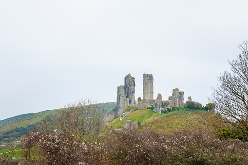 Corfe Castle, the famous old castle and travel destination in Dorset, sourth England. daytime, overcast
