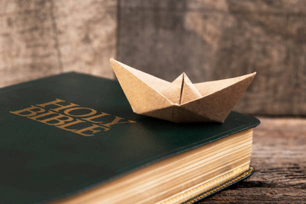 istock Holy Bible and paper boat 2010596797