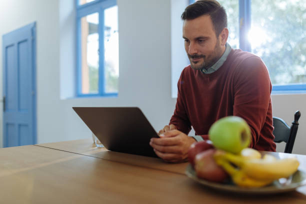 istock Man working from home in the dining room 2010605242