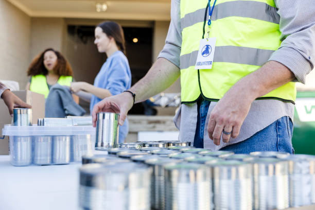 istock Focus on unrecognizable male volunteer sorting canned food 2010606319