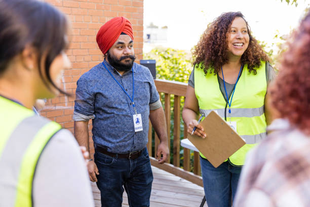 istock Distracted by unseen person, multiracial group prepares to volunteer 2010606824