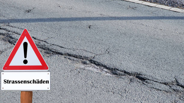 istock Road sign warning against damaged roadway 2010613700