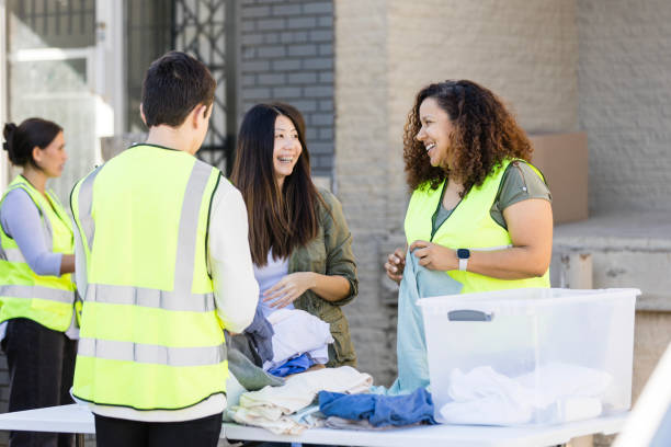 istock Volunteers get to know each other while sorting donated clothing 2010615916