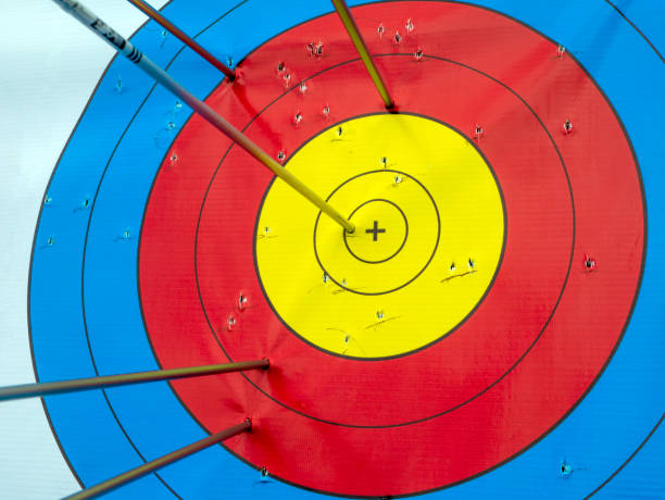 Many arrows hitting the archery target, bulls eye.