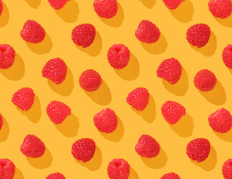 Pattern with raspberries on yellow background