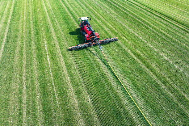 istock Grassland slurry injector in a field seen from above 2010659702