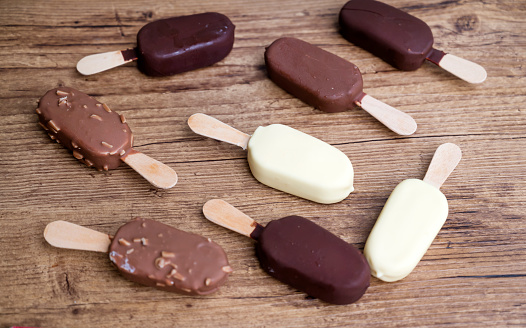 Ice cream sticks with chocolate and almonds