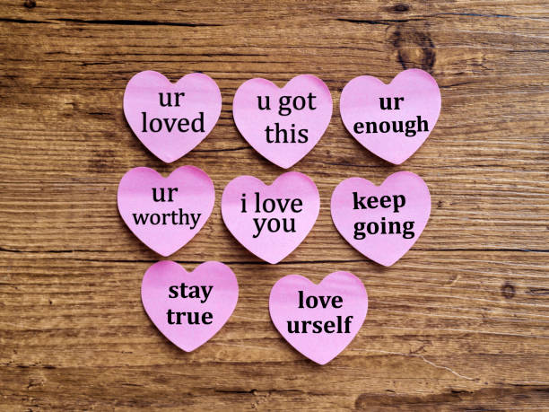 Love you written on many heart shape sticky notes
