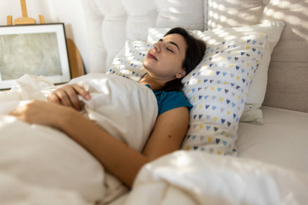 istock Young woman sleeping in bed 2010682399