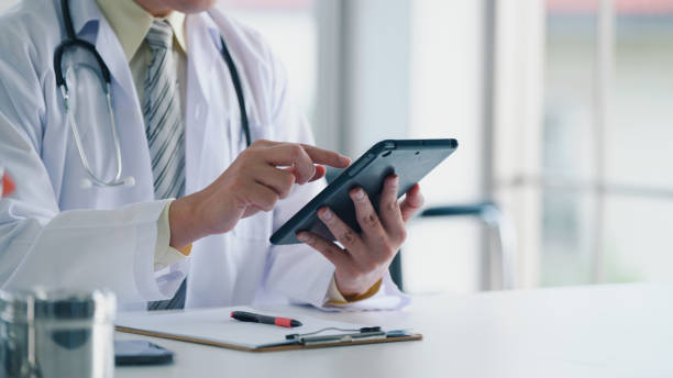 istock Doctor sits and checks patient information on a tablet. 2010685570