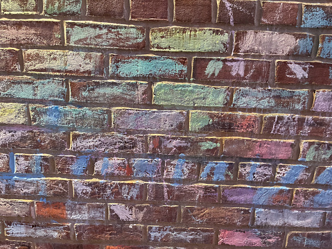 View of colored brick wall with chalk