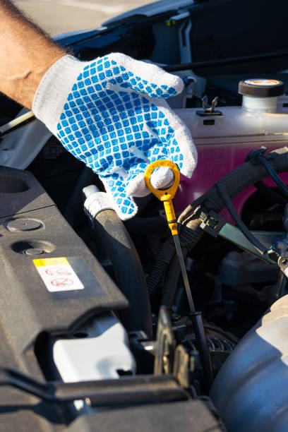 istock man checking the level of motor oil in a car engine 2010707902