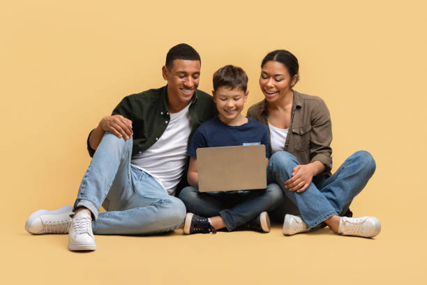 istock Beautiful family watching movie together, using laptop 2010725076