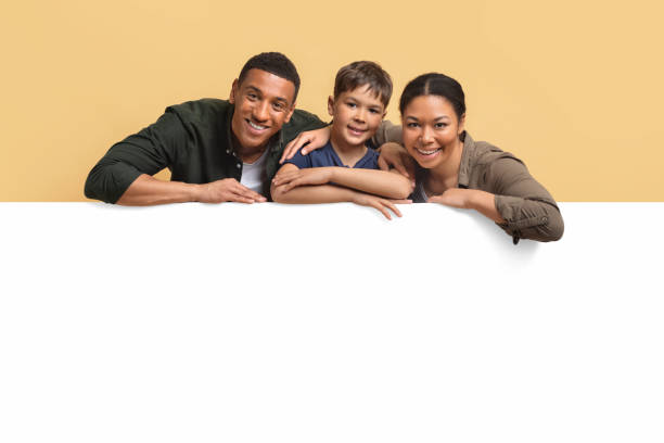 istock Beautiful family leaning on horizontal advertising board 2010725604