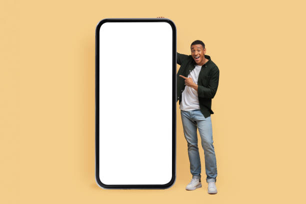 istock Excited young black man posing by phone with white screen 2010725606