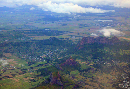 Mauritius island, Indian Ocean: aerial view - basaltic mountains with serrated ridges - there are 31 named mountains in Moka, the tallest being Pieter Both  (820 m) and Le Pouce  (811 m) peaks. The light green areas are sugarcane plantations.