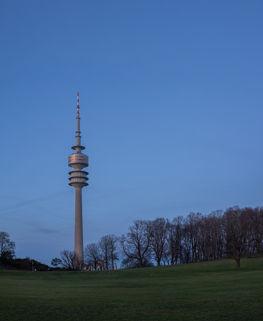 On December 30th 2023, The 291 meters high (955ft) Olympic Tower in Munich during blue hour.  Opened 1n 1968 has a view deck and a revolving restaurant oboe. It serves as a broadcast tower.