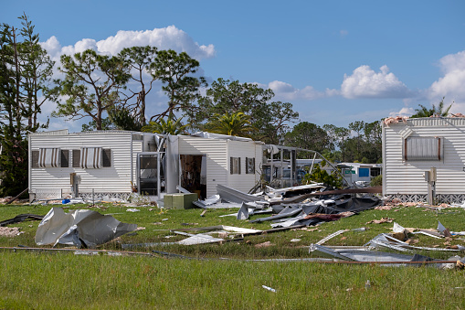 Collapsed and damaged mobile homes after hurricane swept through Florida residential area. Consequences of severe natural disaster.