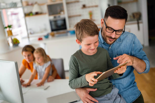 istock Distance learning, online education, home work concept. Family with digital devices at home. 2010767788
