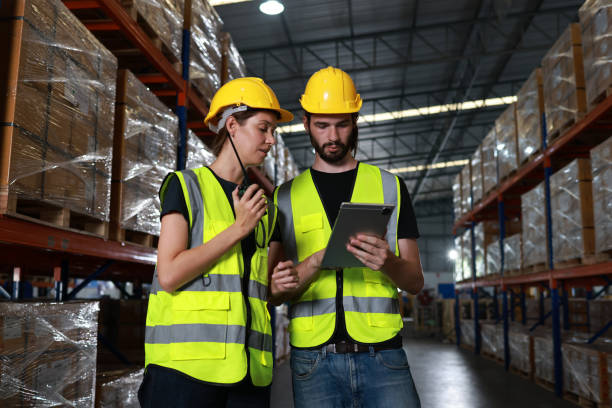 istock Two distribution warehouse coworkers are walking using a digital tablet to check inventory on a physical count 2010773643