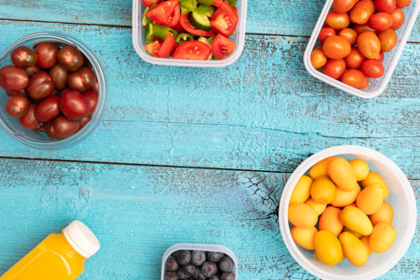 Fresh salad healthy and fresh fruit on blue background