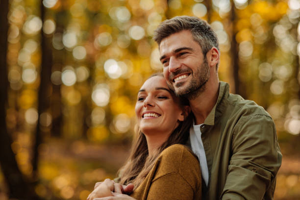 istock Couple in love hugging and walking in the forest 2010830153
