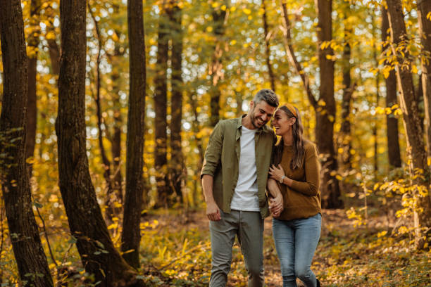istock Lovely couple hugging and walking in the forest 2010830155