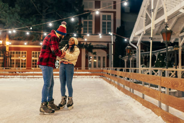 istock Biracial couple ice skating at outdoors rink 2010842273