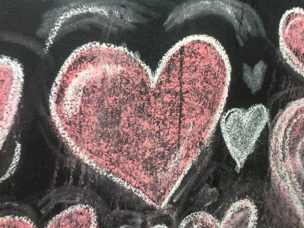 Heart-shaped colored pencil scribbles on the floor