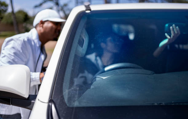 istock Indian girl student adjusting rear view mirror while learning to drive car 2010866215