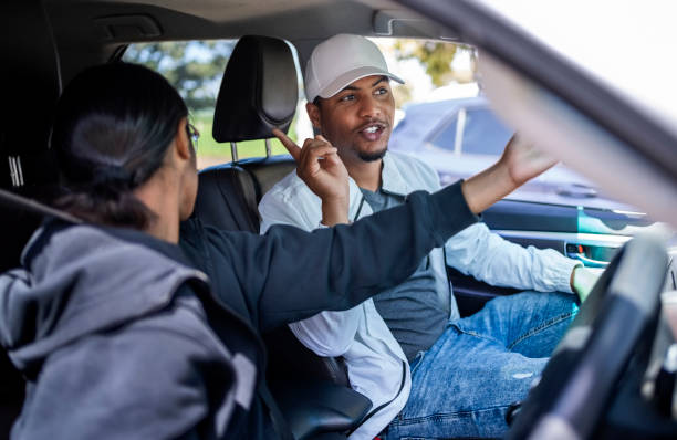 istock Driving instructor explaining the driving basics to girl learning to drive a car 2010866801