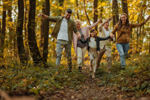 istock Whole family happily strolling in the woods 2010869523