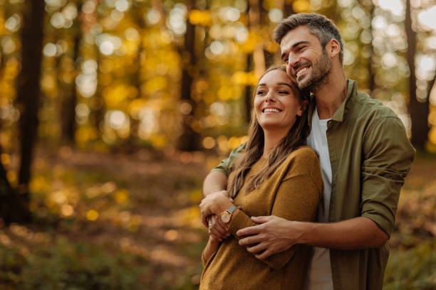istock Couple in love hugging and walking in the forest 2010871114