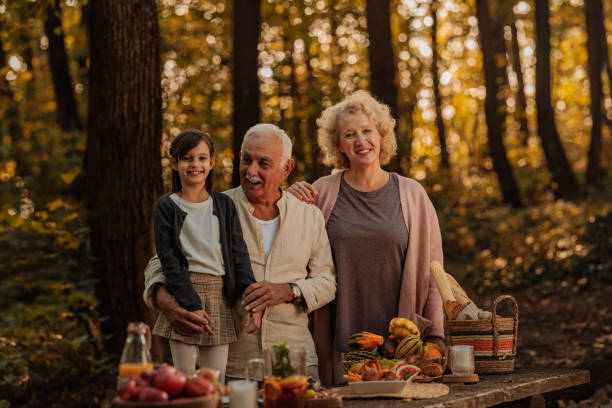istock Family having a picnic in the forest on fall 2010878082