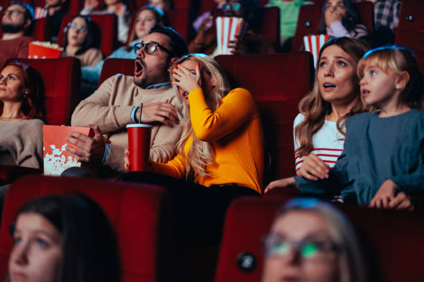 istock Scared couple in movie theater. 2010878096