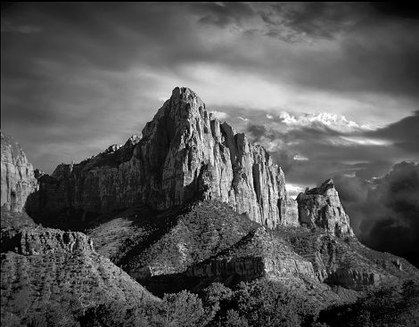 Beautiful black and white landscape of Zion National Park bathed in late evening sunlight with stunning cloud formation.